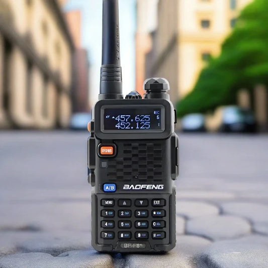 Black handheld two-way radio with a digital display and keypad.