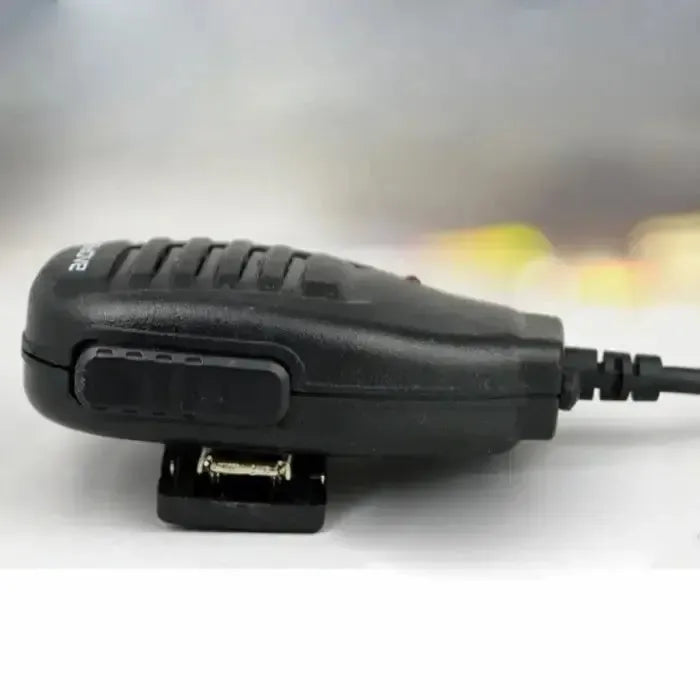 Black handheld speaker microphone with a clip.