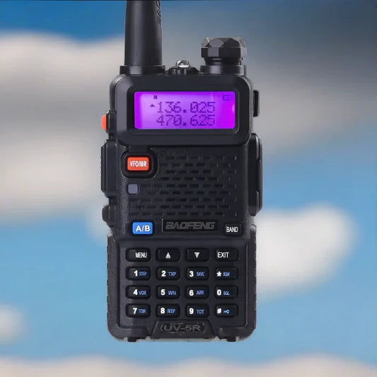 Black two-way radio with a purple backlit display.