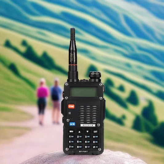 Black handheld two-way radio with an antenna and a numeric keypad.