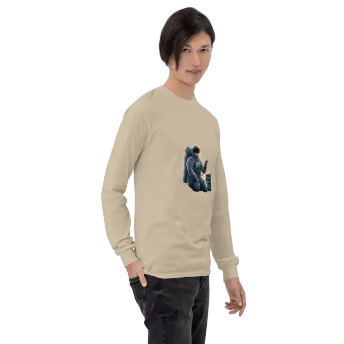 Beige long-sleeved shirt with astronaut graphic.