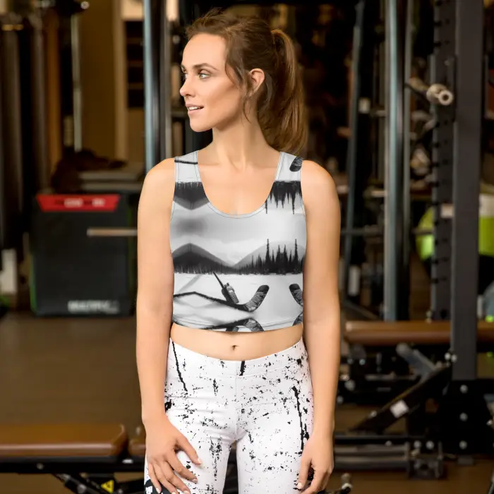 Woman wearing a patterned crop top and leggings.