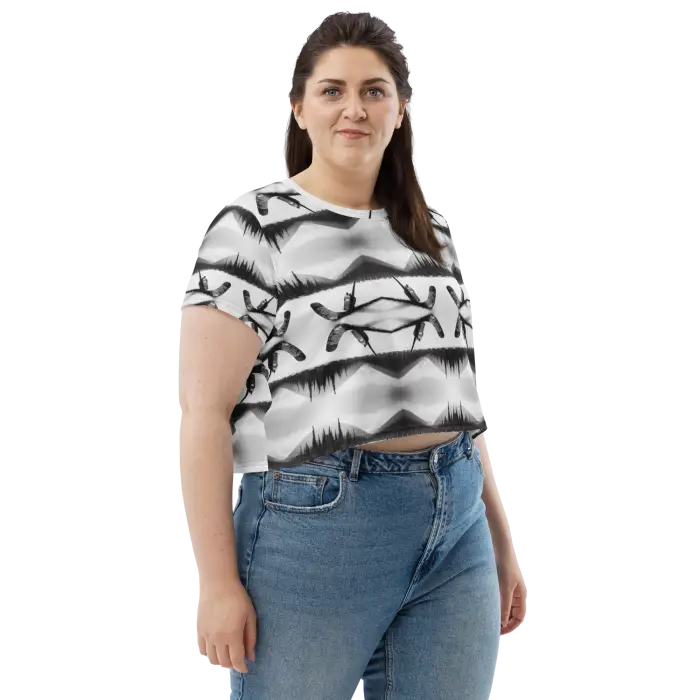 Woman wearing patterned crop top and jeans.