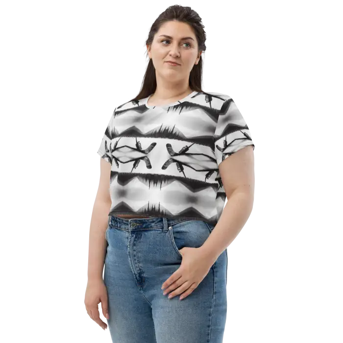 Woman wearing patterned crop top and jeans.