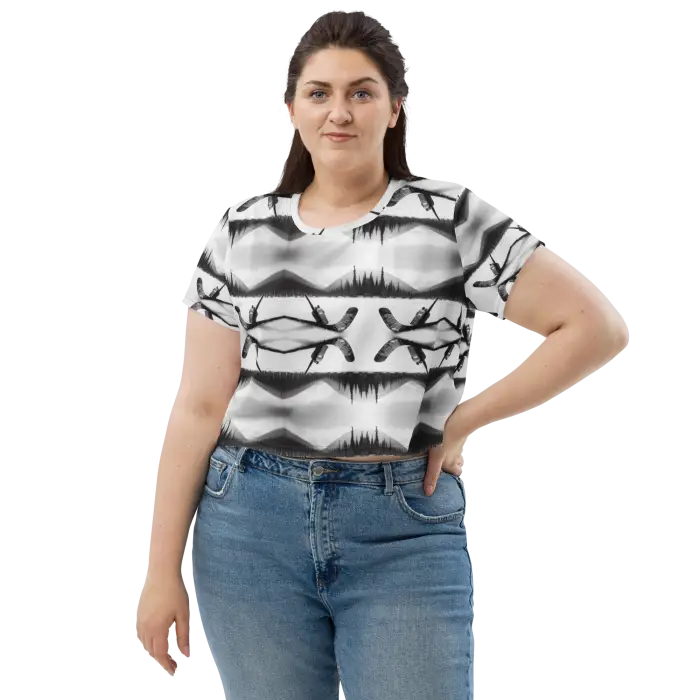 Woman wearing a patterned crop top and jeans.