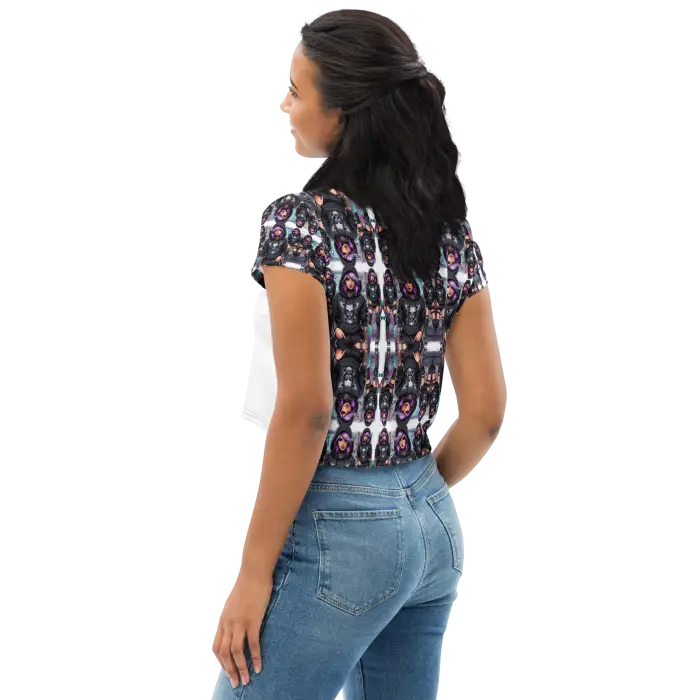Woman in patterned crop top and jeans.
