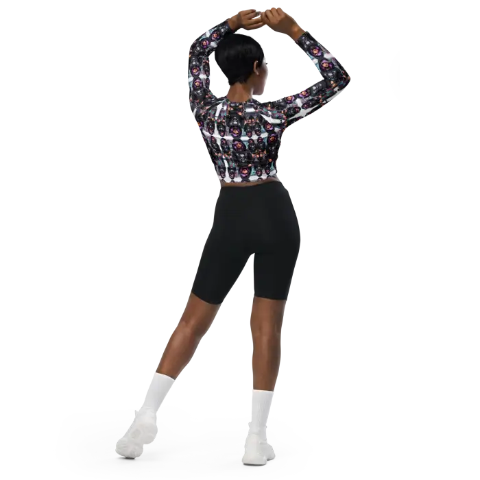 Woman in patterned crop top and black shorts.