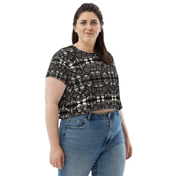 Woman wearing skull-patterned crop top and jeans.
