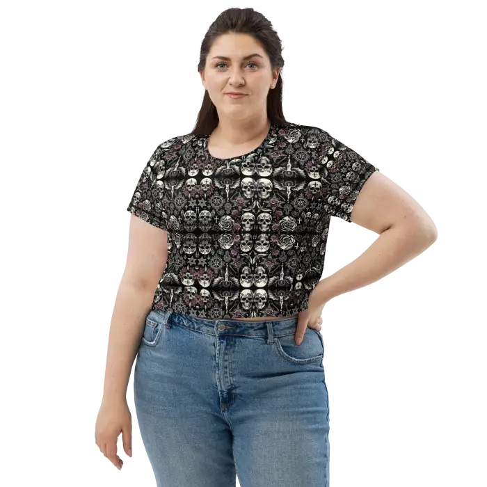 Woman wearing skull-patterned crop top and jeans.