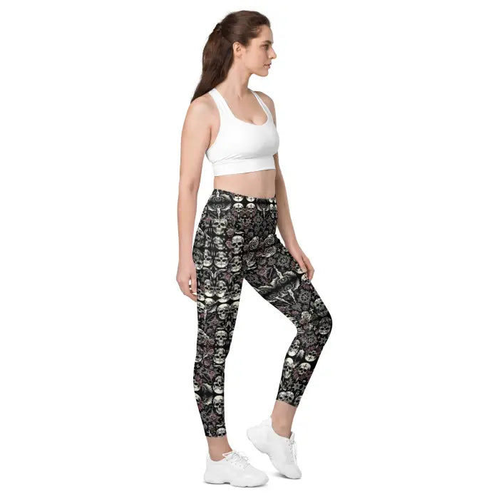 Woman wearing skull-patterned leggings and a white sports bra.