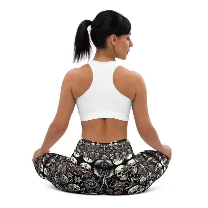 Woman wearing skull-patterned leggings and a white sports bra.