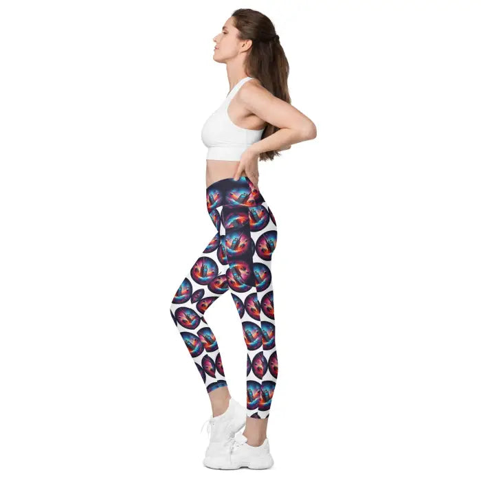 Woman wearing patterned leggings and a white sports bra.