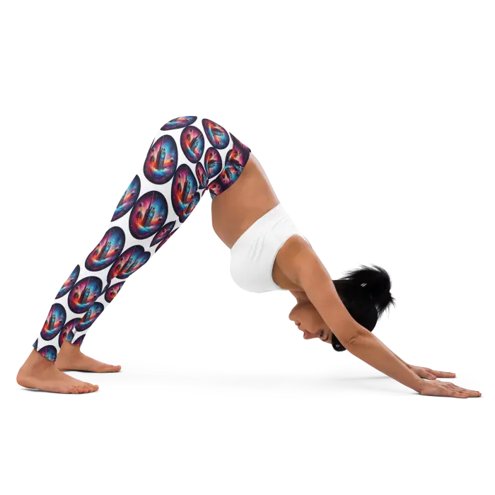 Woman in downward dog pose wearing patterned leggings.