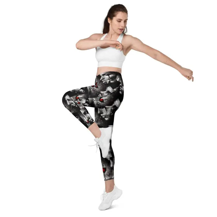 Woman in patterned leggings and sports bra.