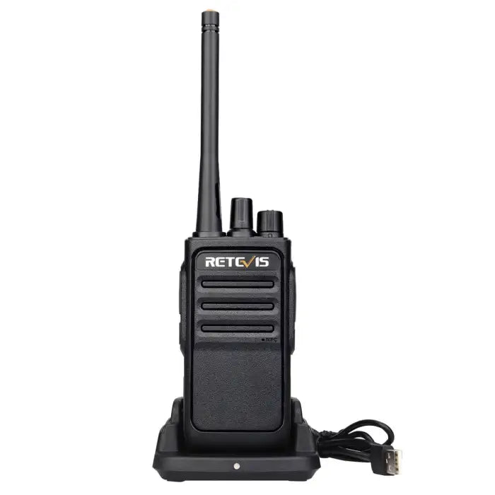 Black two-way radio on charging base.