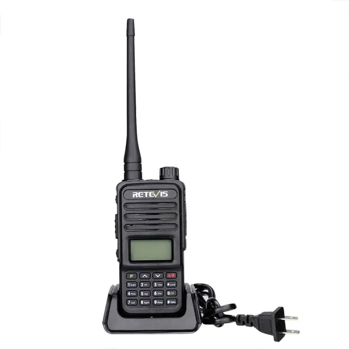 Handheld two-way radio with antenna, display screen, keypad, and charging base.
