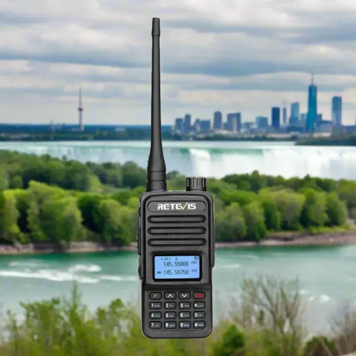 Handheld two-way radio with an antenna and digital display.