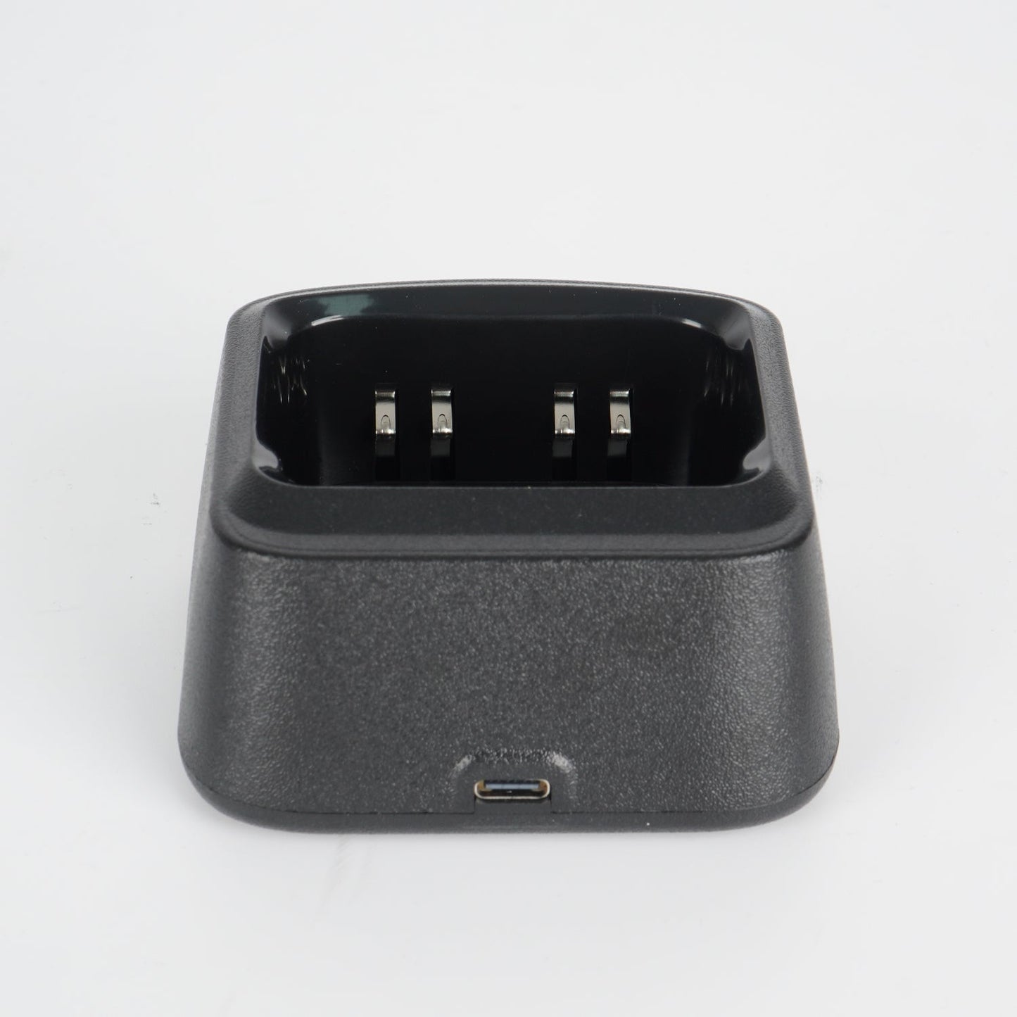 Black charging dock with usb port and three-pronged connector for device charging