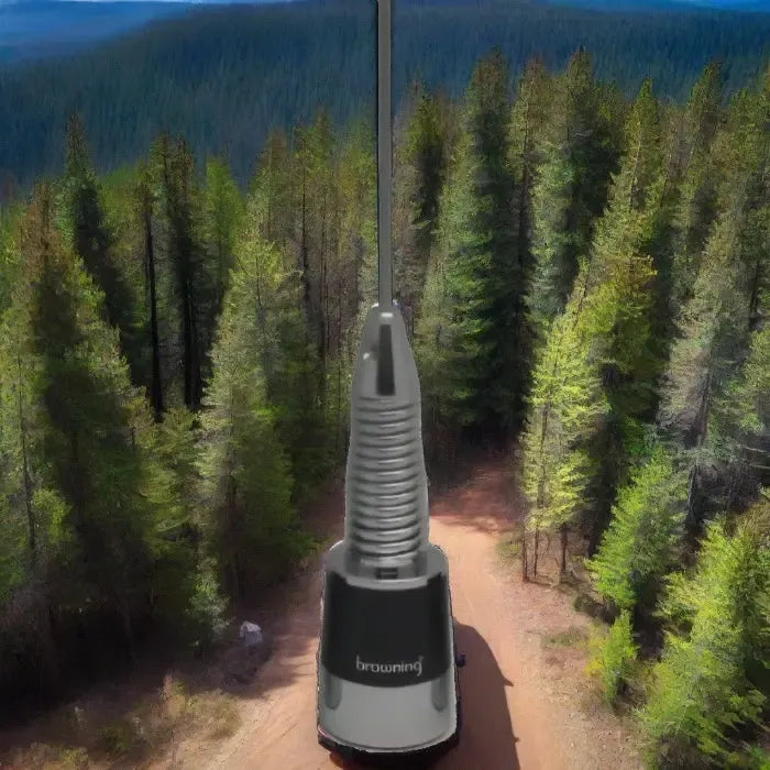 Stainless steel spring loaded NMO antenna in a forest landscape with Tram BR-167-S