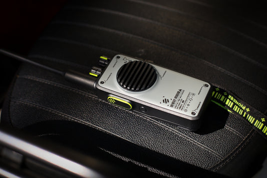 A walkie-talkie sits on a car seat.