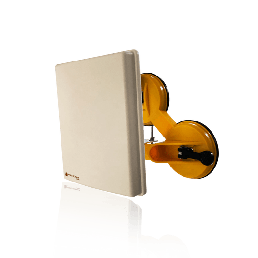 A yellow double suction cup glass lifter attached to a light-colored panel.