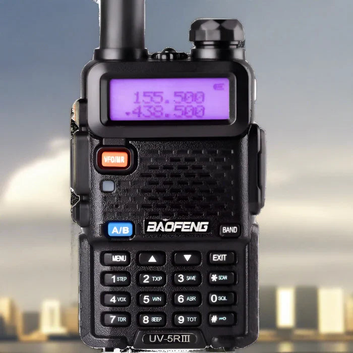 Black handheld two-way radio with a purple backlit display and numeric keypad.
