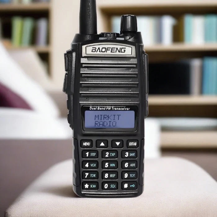 Black handheld dual-band FM transceiver with a keypad and LCD screen