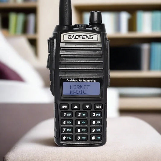 Black handheld dual-band FM transceiver with a keypad and LCD screen