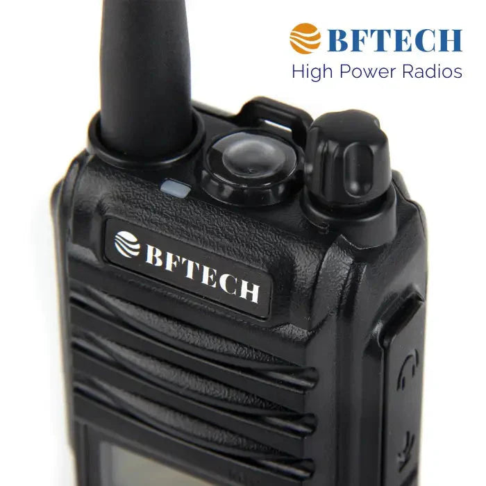Black two-way radio with an antenna and control knobs