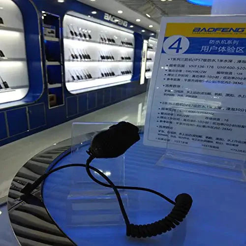 Wired speaker microphone with a coiled cord for a two-way radio.