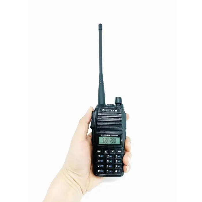 Black handheld two-way radio with a whip antenna and a keypad.