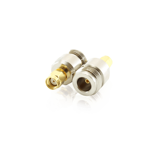 Four RF coaxial adapters with silver and gold-plated finishes.