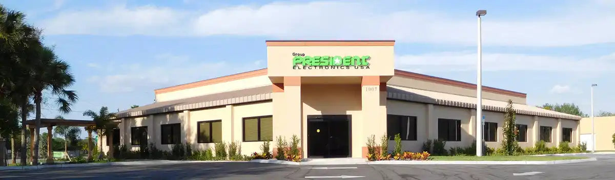 A one-story commercial building with a light-colored exterior and a brown roof.