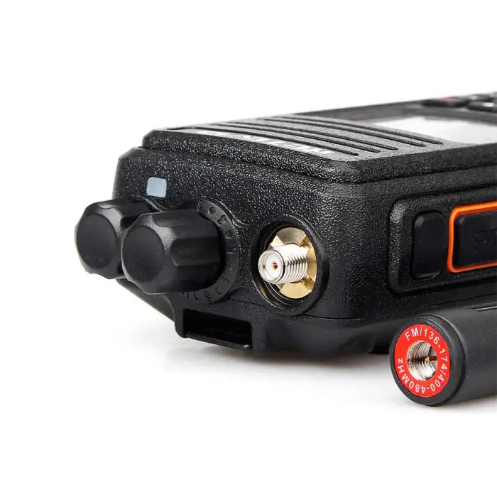 Black two-way radio with antenna connector.