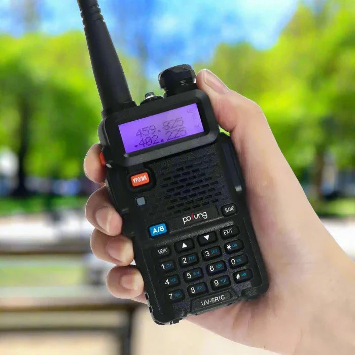 Black two-way radio with a purple backlit display and keypad.