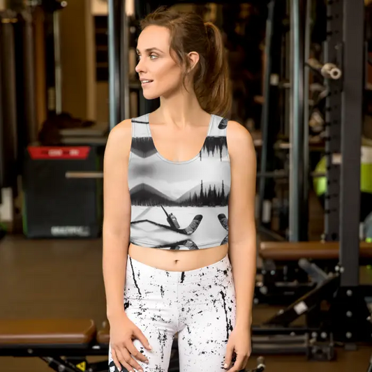 Woman wearing a patterned crop top and leggings.