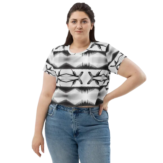 Woman wearing a patterned crop top and jeans.
