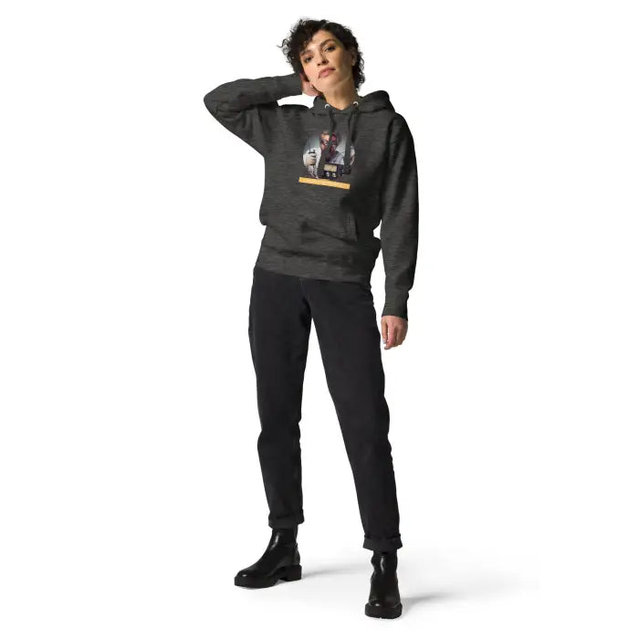 Woman wearing a graphic hoodie and black pants.