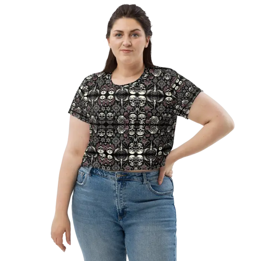 Woman wearing skull-patterned crop top and jeans.