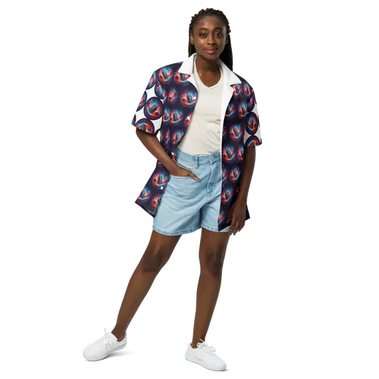 Woman in patterned shirt and denim shorts.