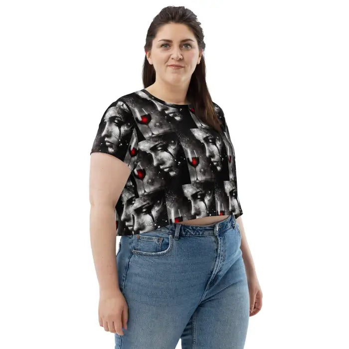 Woman wearing a patterned crop top and jeans.