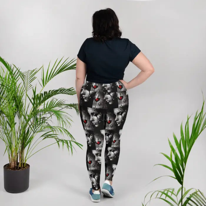 Woman wearing leggings with a face and wine glass pattern.