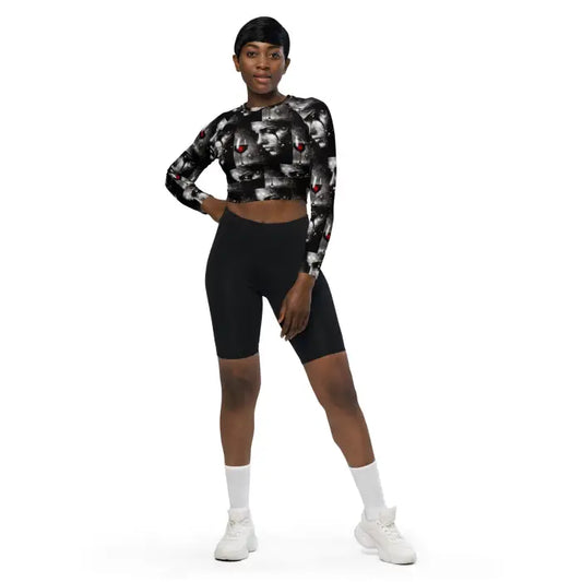 Woman wearing patterned crop top and black biker shorts.