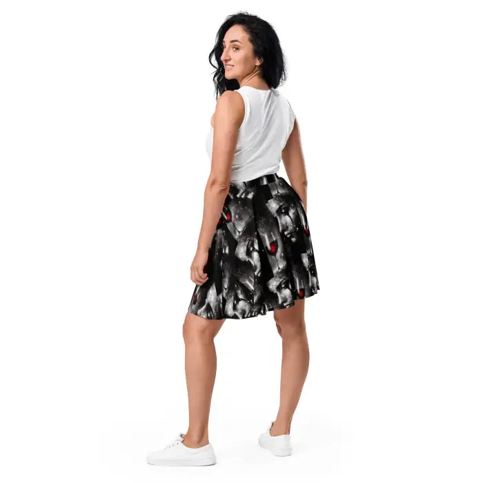 Woman wearing a white top and patterned skirt.