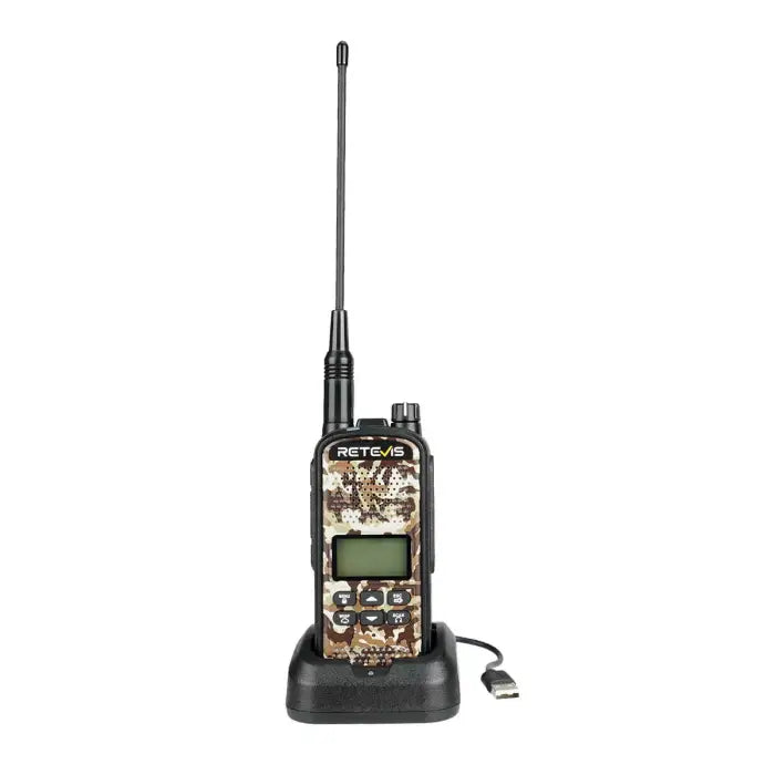 Camouflage two-way radio on charging base.
