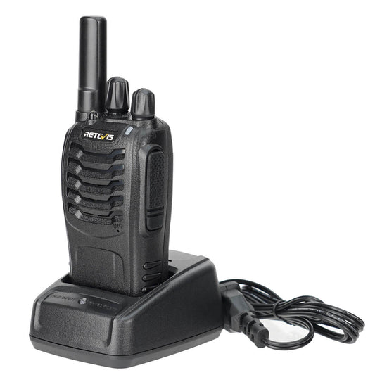 Black two-way radio with charging base.