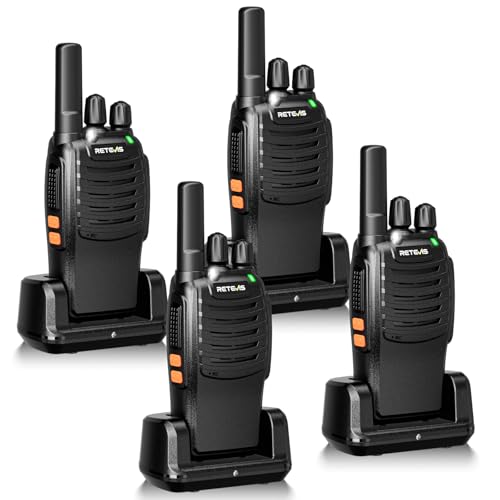 A set of four black two-way radios with charging bases.