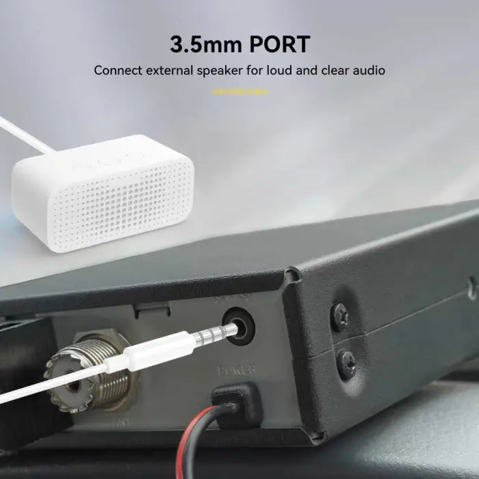 Black radio with connected speaker.