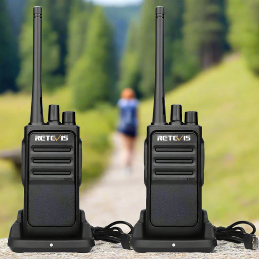 Two black walkie-talkies with charging docks.