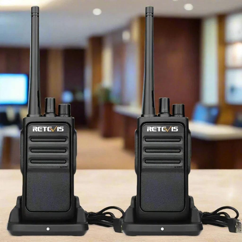 Two black walkie-talkies with charging docks.